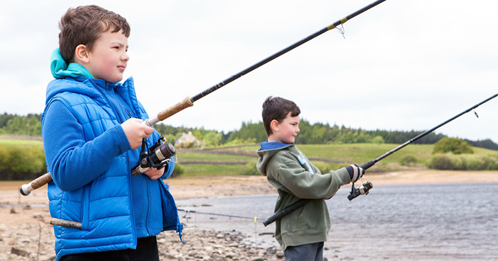 boys fishing at a reservoir 